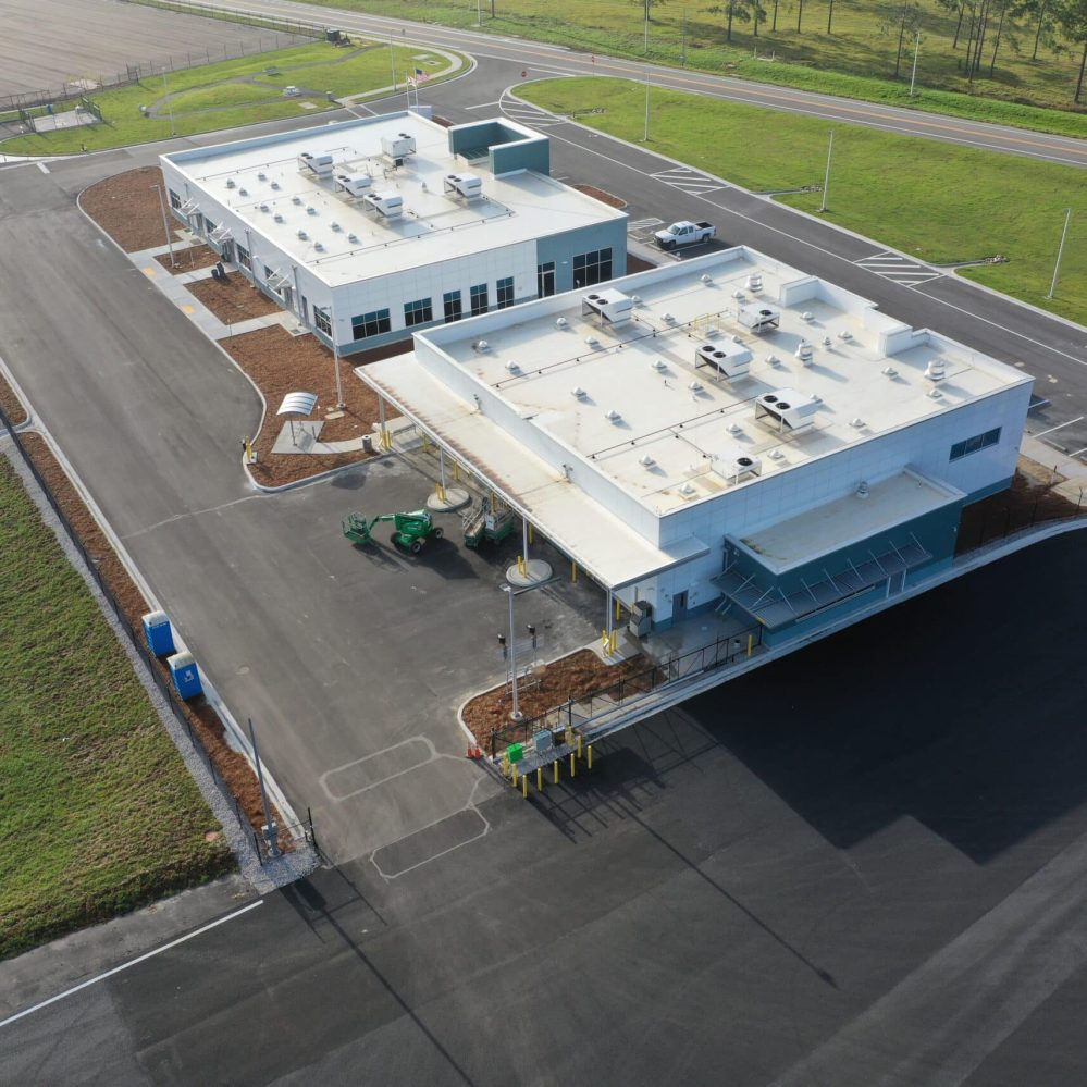 An aerial view of a building with a parking lot.